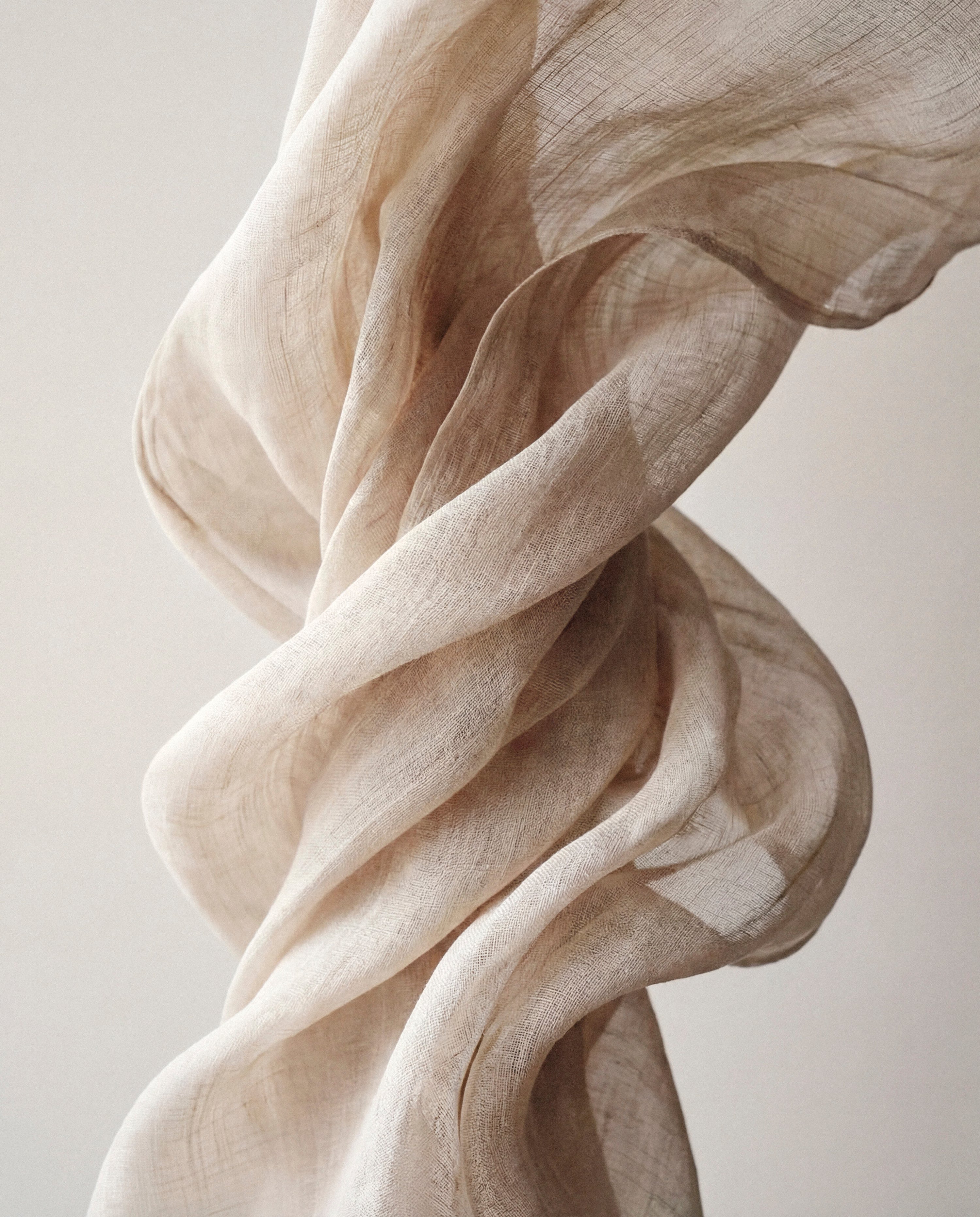 Soft draped linen fabric in neutral tones representing the Protect skincare collection by Katie England