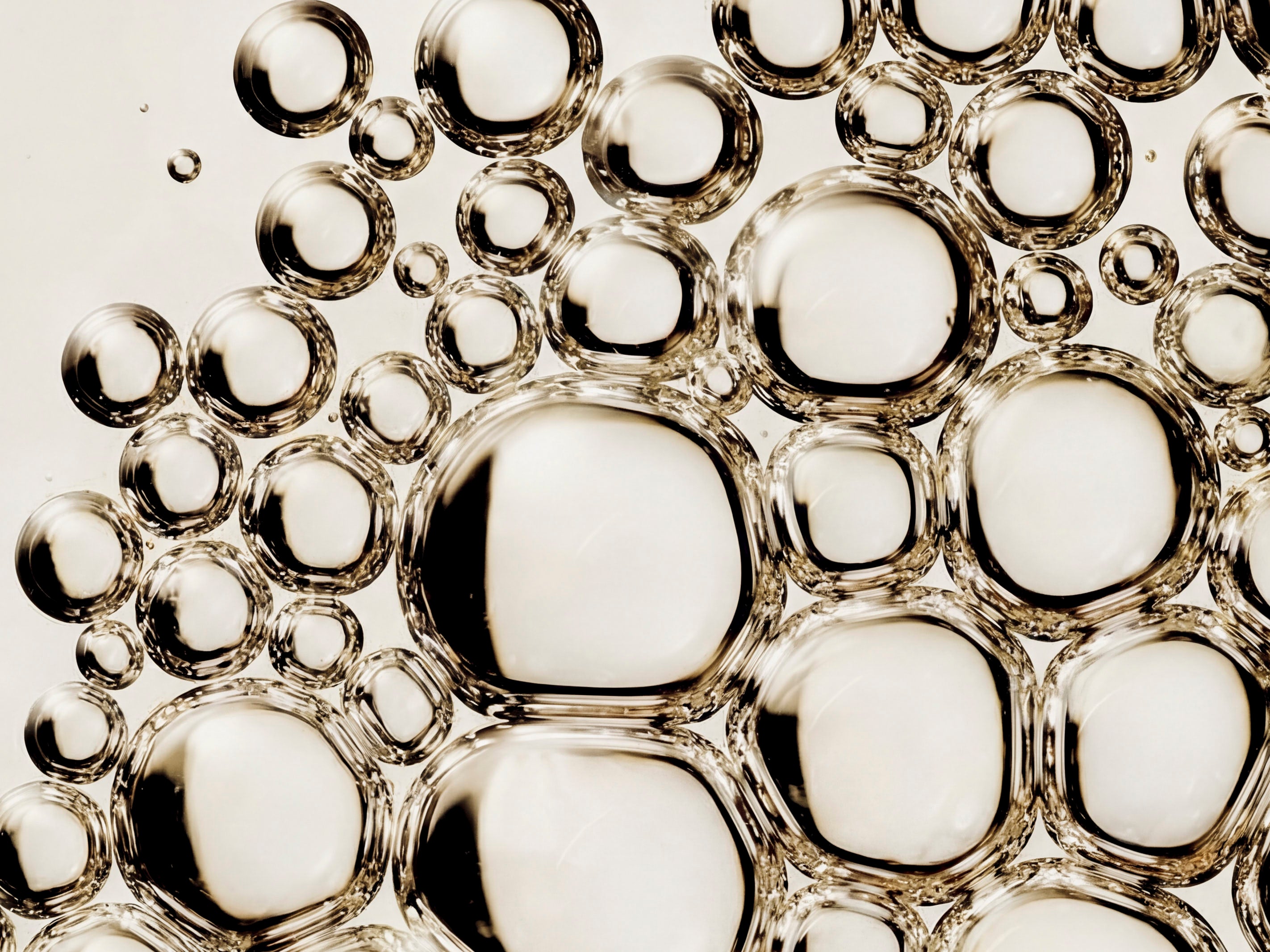 Macro close-up of golden skincare oil bubbles showing serum texture and consistency